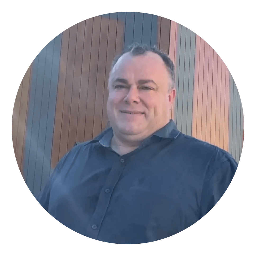 Photo of man standing outside in front of a building