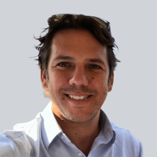 A photo of a smiling man in a button-down shirt