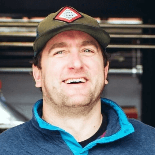 A photo of a man smiling in a hat. His name is Jack Dyer.