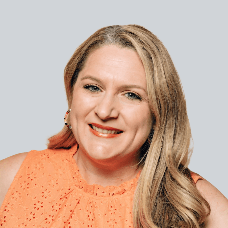 A photo of a smiling woman on a gray background. She's on the Crafted EPR marketing team!