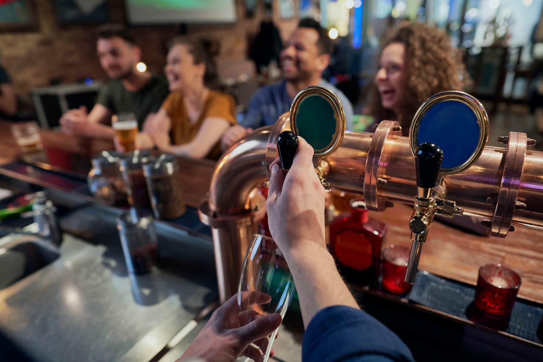 Close up of bartender serving beer at a craft brewery