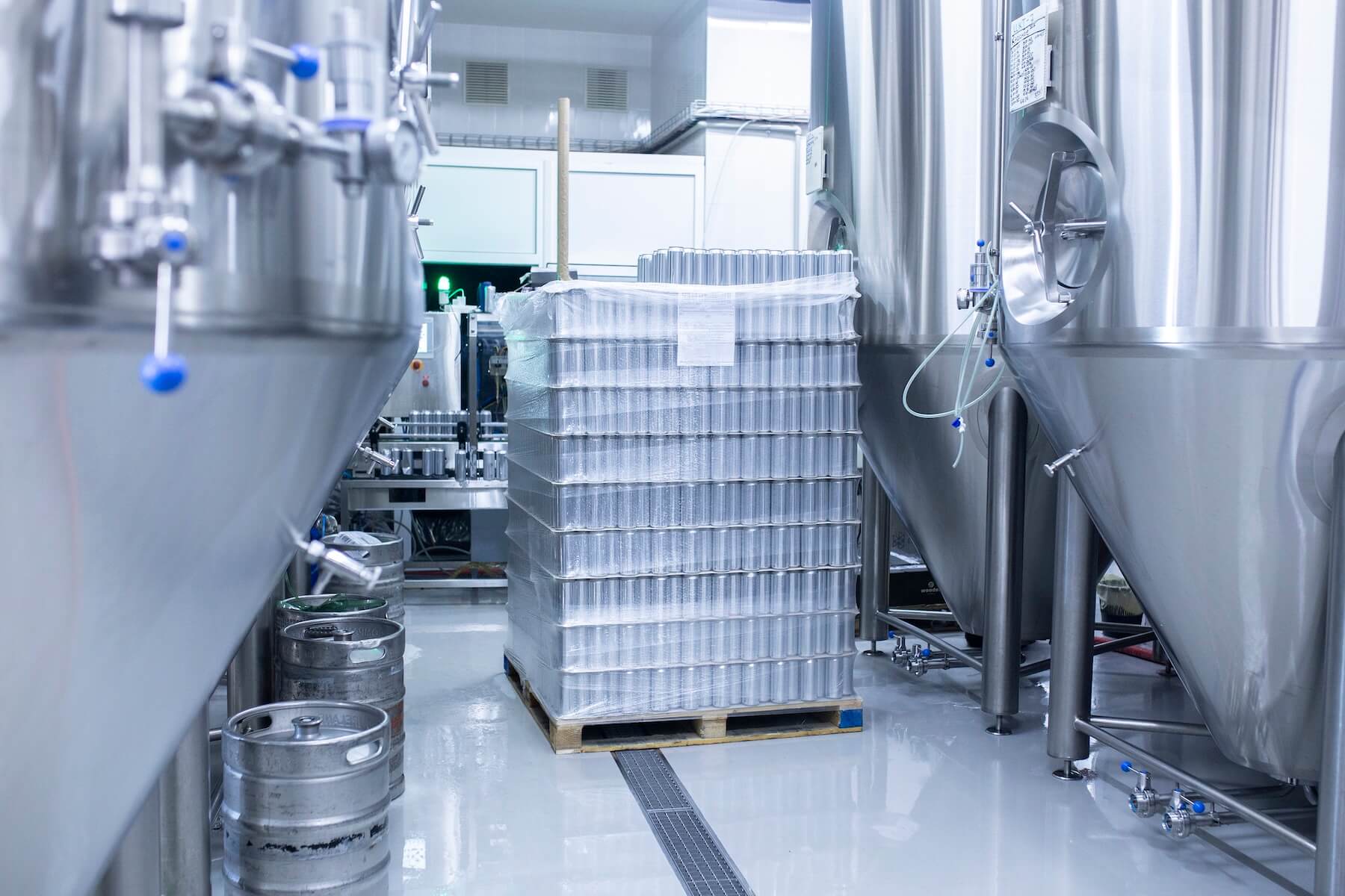 a stack of new aluminium cans on the at a brewery