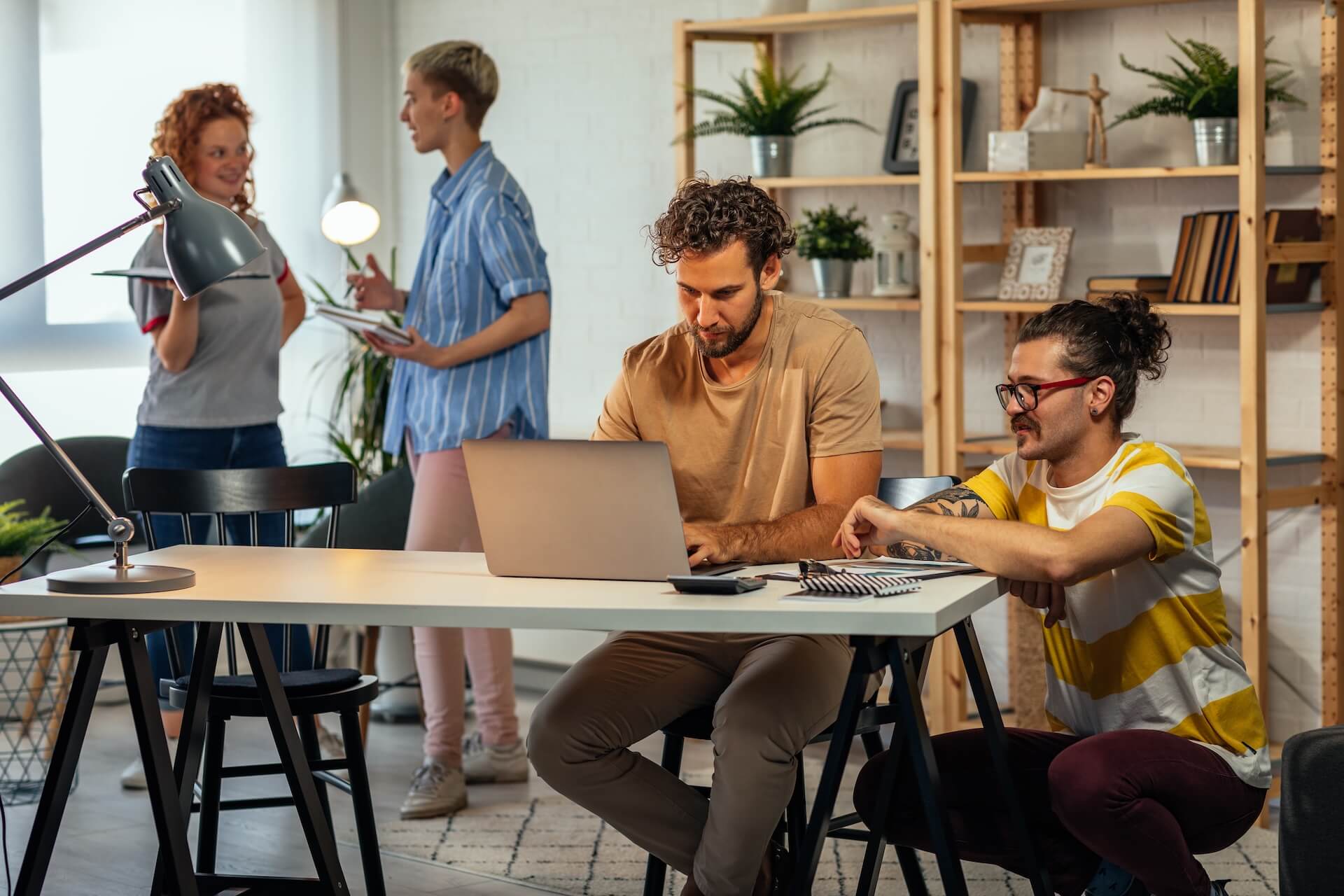 A group of young brewery employees in an office working on ERP pre-kickoff preparation