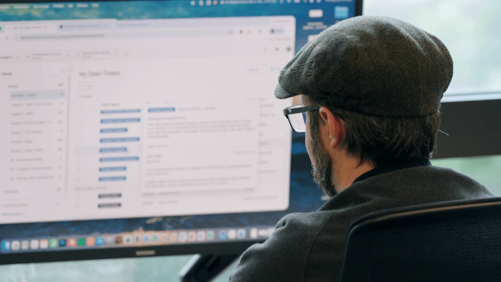 A man working in the Doozy Solutions office on Crafted ERP